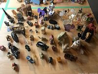 Wide shot of entire assortment of elephant figurines on table