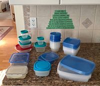 All containers grouped on countertop showing different stacks and lid colours