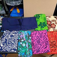 Group of assorted folded fabric pieces showing six patterns