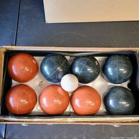Case open showing 8 bocce balls and pallino