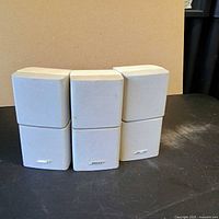 Front view of three Bose double-cube speakers