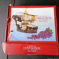 Outer red box with product image and multilingual corkscrew label