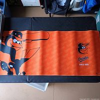 Full view of Baltimore Orioles orange desk pad on table