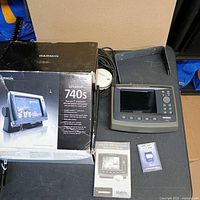 Overall lot with Garmin GPSMAP 740S box, Humminbird Matrix 97 head unit, antenna, cables, manual and SD card visible