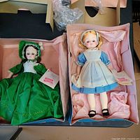 Both dolls in boxes showing attire and hang-tags