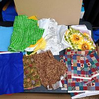 Group view of assorted printed fabrics and some felt sheets