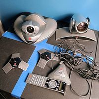 Overview of all Polycom components including integrated codec camera, external camera, two microphone pods, remote and cables