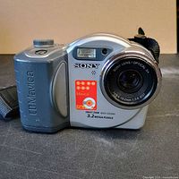 Front angled view of Sony MVC-CD350 camera showing lens, model badge, and strap