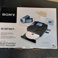 Front of retail box showing Sony DVDirect VRD-MC6 recorder, compatible devices and memory cards