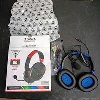Boxed Turtle Beach Recon 50 headset, mic, splitter cable, pouch laid out