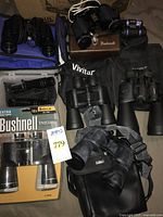 Assorted binoculars from Bushnell, Barska, Vivitar plus telescope accessories
