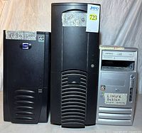 Front view showing three tower cases: silver HP Compaq and two black Antec