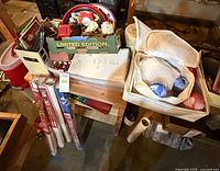 Overall lot with wrapping paper rolls, ornament storage case, box of carousel ornaments and ribbon items