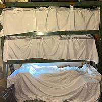 Front view of assembled metal shelving showing three shelves