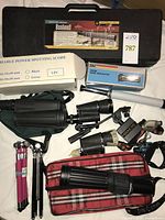 Top-view of lot with scopes, binoculars, tripods, cases and accessories
