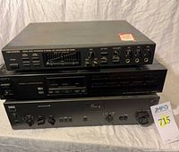 Three stacked audio units: Nikkodo processor top, Sony tuner middle, NAD amplifier bottom, with lot tag visible.