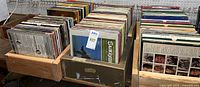 Three wooden boxes filled with numerous LP records