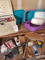 overall lot on shelves showing sewing box, storage bin, trims, fabric, jars and other supplies