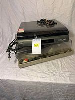 Both turntables stacked with cords and dust covers