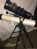 Celestron AstroMaster 130EQ and Galileo HQR-800 telescopes on tripods