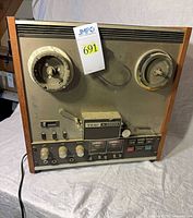 Front view of TEAC A-3300S reel-to-reel tape deck showing full panel and reel hubs