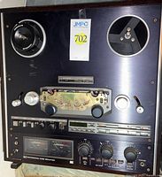 Front view showing reel hubs, control panel, meters