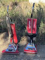 Both Sanitaire uprights standing side by side outdoors