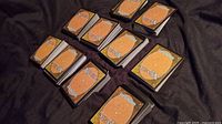 Stacks of MTG cards backs on black cloth