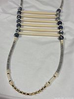 Full view of necklace showing bone tubes, blue stone beads and heishi strand