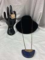 Necklace and ring displayed together