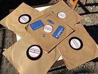 Five oversized AFRS records in kraft sleeves arranged on table