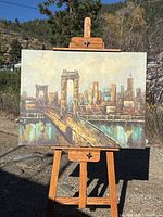 Full view of oil painting on easel outdoors