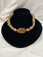 Full view of lemon agate necklace on display bust