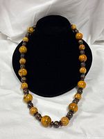 Full view of necklace on bust, showing bead pattern and length