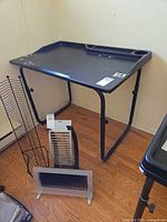 Overall view of black plastic-top adjustable table