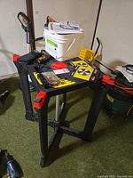 Overall lot showing work table, Trex bucket, saw blades, small tools