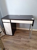Full front view of desk showing cabinet and metal leg
