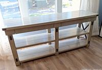 Front view of full console table showing top, drawers, shelves, finish