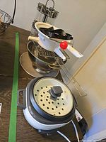 Group shot showing rice cooker, strainer, bowl, mandoline parts, ring molds, spice rack