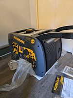 Generator on floor showing control panel and labels