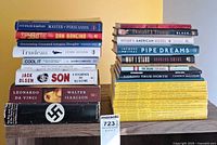 Two stacks of books with row of National Geographic magazines beneath