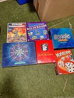 Overview of six board games arranged on floor