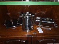 Full lot view showing percolator, stone board, utensils, and two mess trays