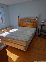 Full view of queen bed frame with mattress and box spring in room