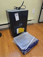 Royal PX1201 shredder with power cord, Oxford file folder box, sheet protectors stacked on top