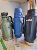 Three insulated beverage containers standing side-by-side