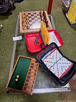 All three travel board games displayed on table