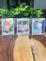 Front view of three sealed 1989 Fleer packs showing visible front cards