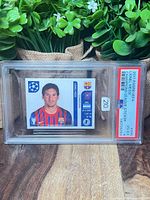 Front of PSA slab showing Lionel Messi sticker