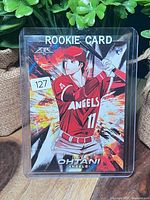 Front view of sleeved Ohtani rookie card, showing anime artwork and Angels branding
